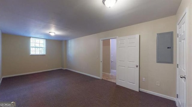 basement featuring electric panel and dark colored carpet