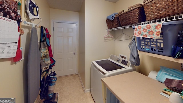 laundry room with washer and dryer and a textured ceiling