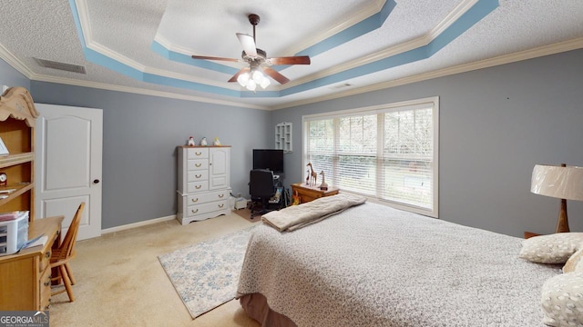 bedroom featuring ceiling fan, light colored carpet, a tray ceiling, and ornamental molding