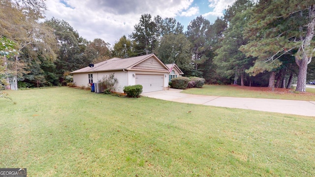 exterior space with a garage, a yard, and central AC