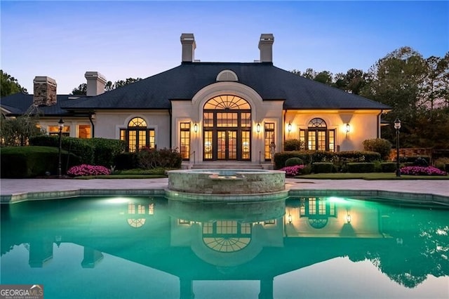 view of pool at dusk