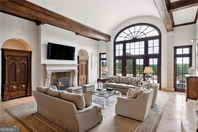 tiled living room featuring plenty of natural light, high vaulted ceiling, and beam ceiling