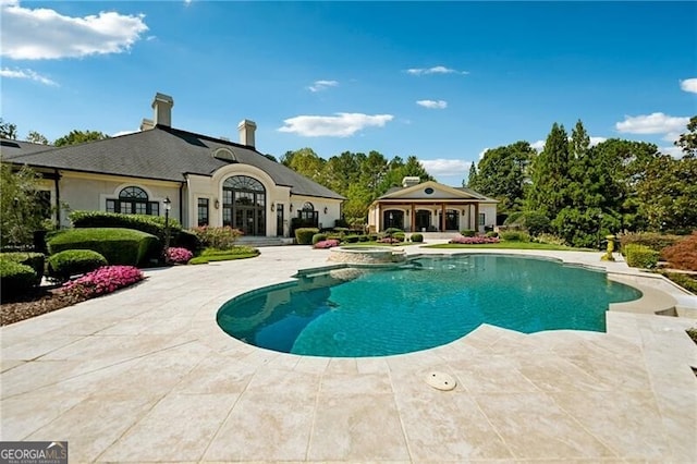 view of pool with an in ground hot tub and a patio