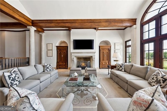 living room featuring ornate columns, light carpet, and lofted ceiling with beams