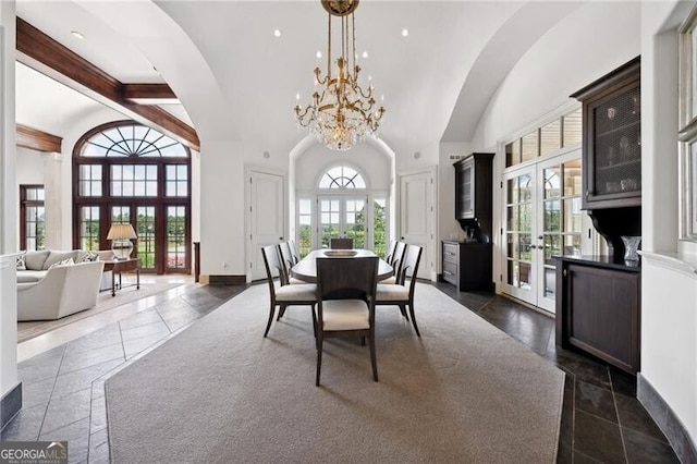 dining space with high vaulted ceiling, a chandelier, french doors, and beamed ceiling