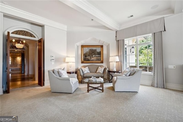 carpeted living room with beamed ceiling and ornamental molding