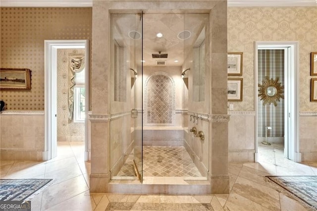 bathroom featuring ornamental molding and tiled shower