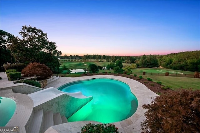 view of pool at dusk