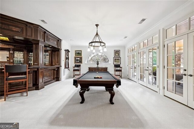 rec room with bar, french doors, light colored carpet, billiards, and crown molding