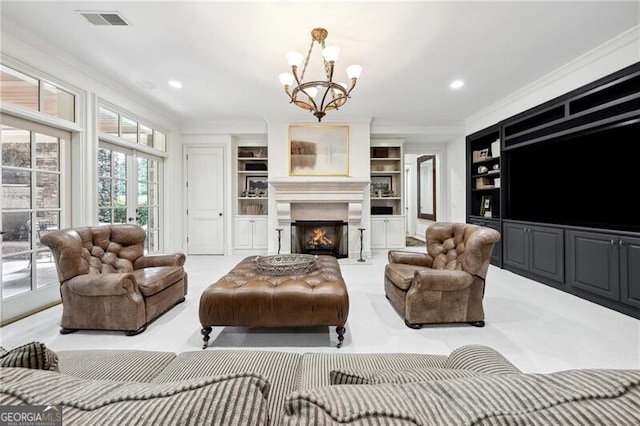 living room with ornamental molding, built in shelves, a chandelier, and light colored carpet