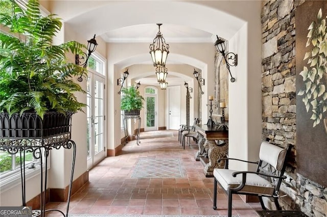 interior space with french doors and crown molding