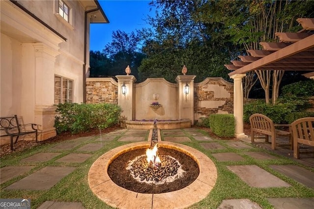 view of patio with an outdoor fire pit and a pergola