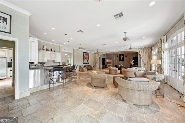 living room featuring crown molding, ceiling fan, and french doors