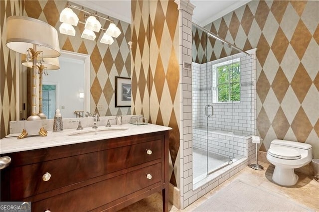 bathroom featuring vanity, tile patterned flooring, crown molding, toilet, and a shower with door