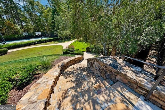 surrounding community with a patio area and a lawn