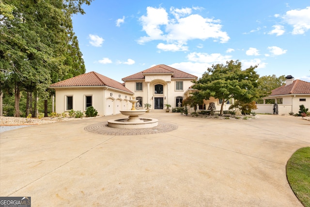 mediterranean / spanish-style home with a garage