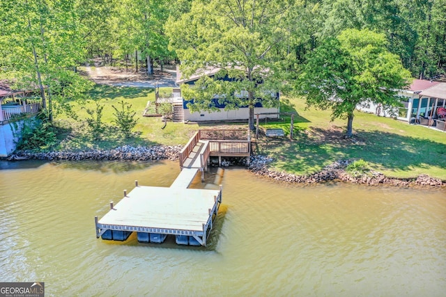 view of dock featuring a water view and a yard