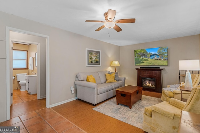 living room with hardwood / wood-style flooring and ceiling fan