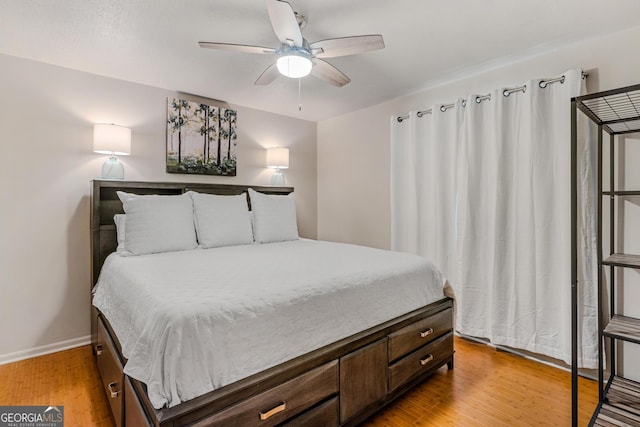 bedroom with ceiling fan and light hardwood / wood-style floors