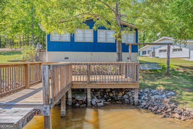 exterior space with a yard and a deck with water view