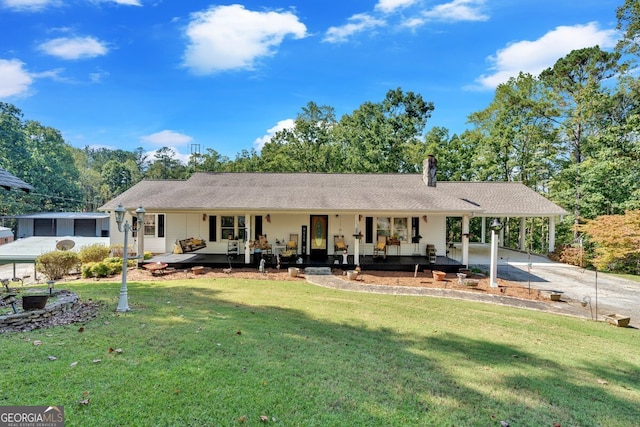 rear view of property with a porch and a lawn