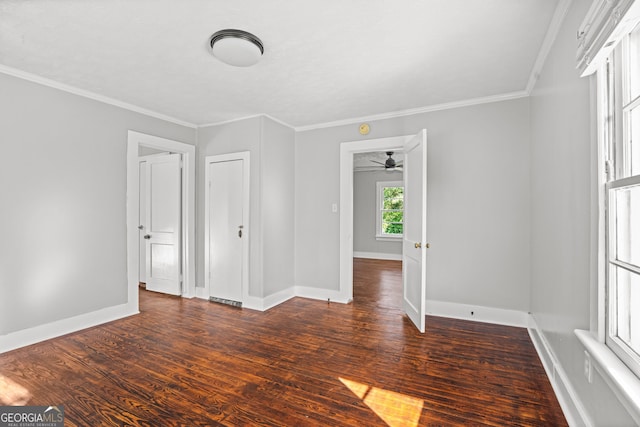 unfurnished room featuring crown molding, ceiling fan, and dark wood-type flooring