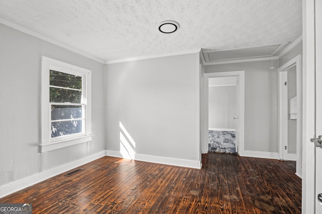 empty room with a textured ceiling, dark hardwood / wood-style floors, and ornamental molding