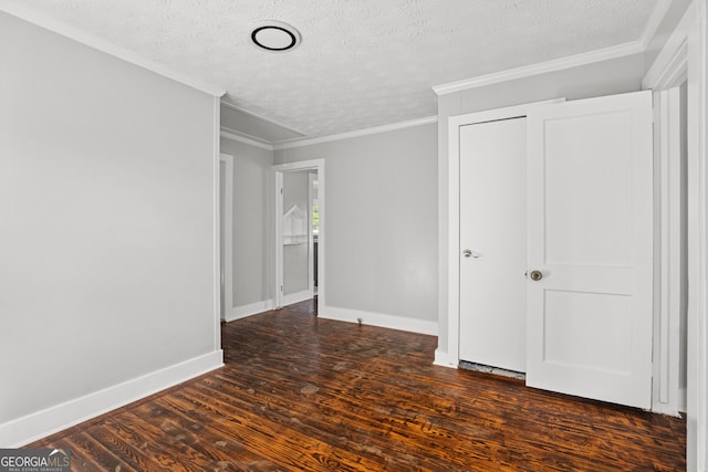 unfurnished bedroom featuring ornamental molding, dark hardwood / wood-style floors, and a textured ceiling