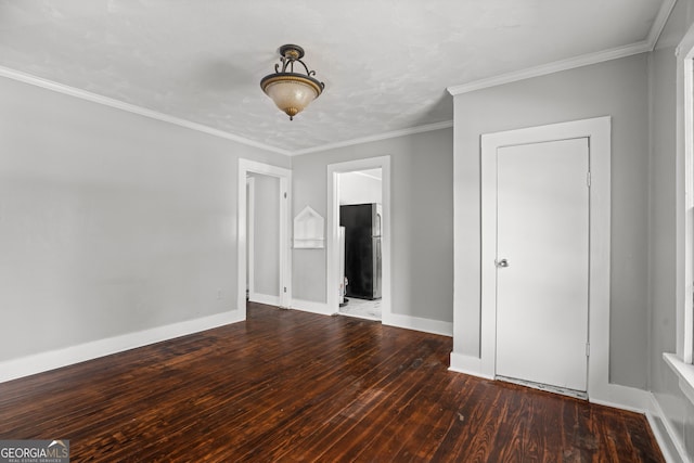 empty room with dark hardwood / wood-style floors and ornamental molding