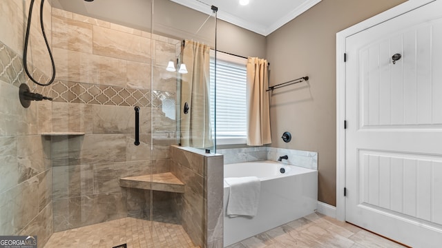 bathroom with ornamental molding and shower with separate bathtub