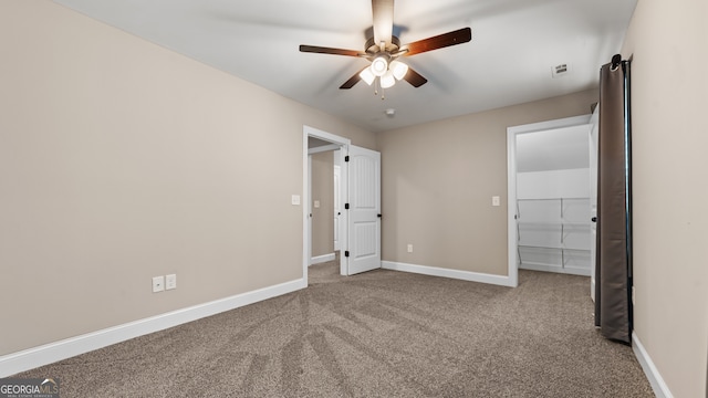 unfurnished bedroom with ceiling fan and carpet flooring