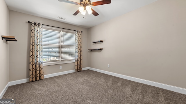 unfurnished room featuring ceiling fan and carpet floors