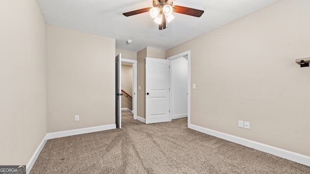 unfurnished bedroom featuring ceiling fan and light carpet