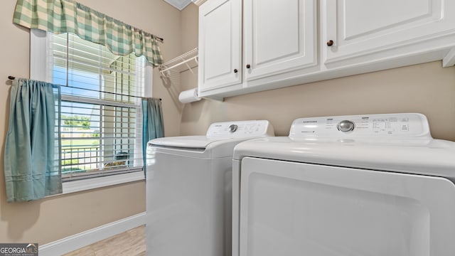 washroom with separate washer and dryer and cabinets