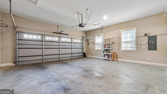 garage with a garage door opener and electric panel