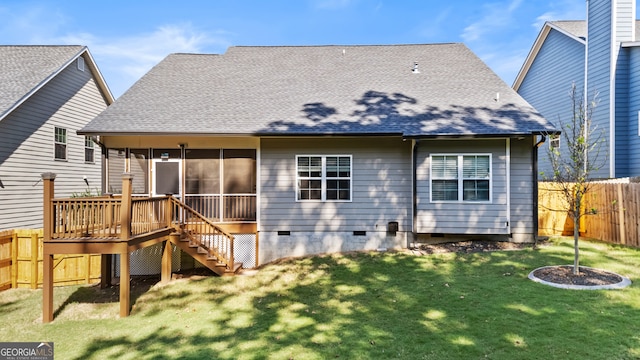 back of house featuring a yard, a sunroom, and a deck