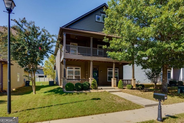 view of front facade with a front yard, central AC unit, and covered porch