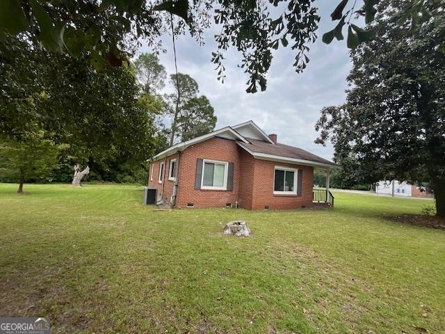 view of property exterior with a lawn