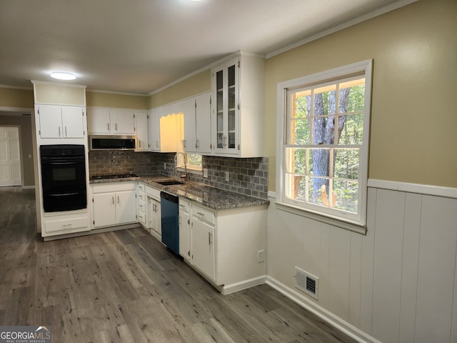 kitchen featuring black appliances, light stone countertops, sink, extractor fan, and white cabinetry