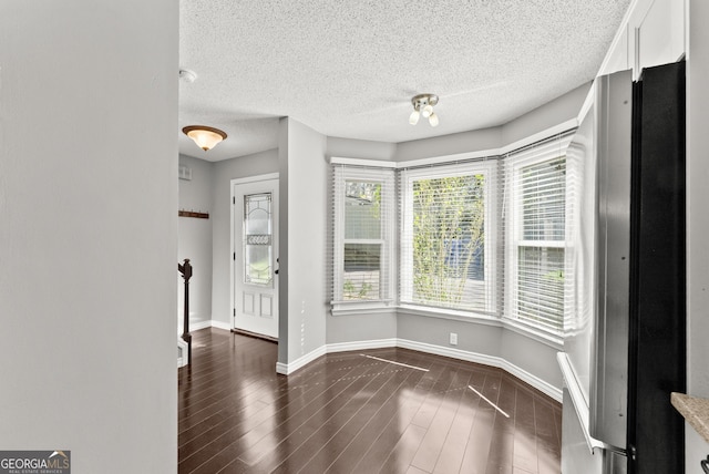 interior space featuring dark hardwood / wood-style floors and a textured ceiling