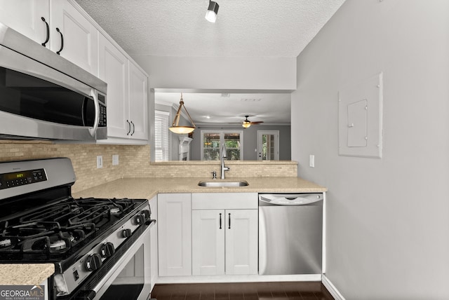 kitchen featuring dark wood-type flooring, white cabinetry, sink, and stainless steel appliances