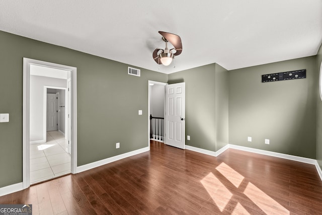 unfurnished bedroom with hardwood / wood-style flooring and a textured ceiling