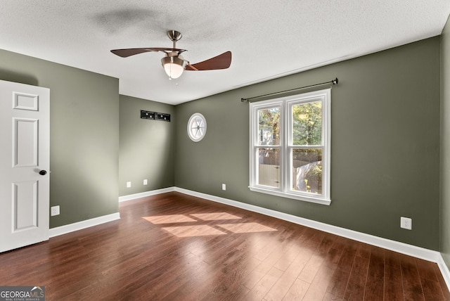 unfurnished room with ceiling fan, wood-type flooring, and a textured ceiling