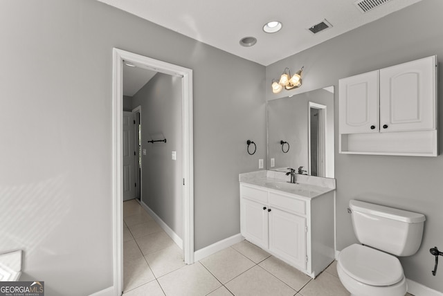 bathroom with tile patterned flooring, vanity, and toilet