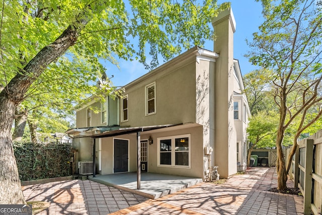 rear view of house with a patio and central air condition unit