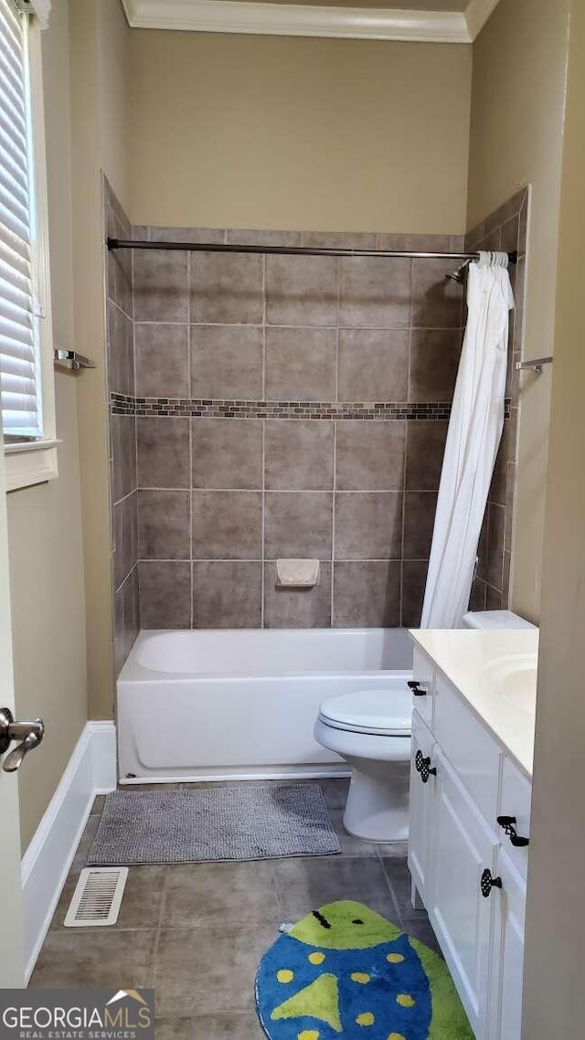 full bathroom with toilet, tile patterned flooring, ornamental molding, shower / tub combo with curtain, and vanity