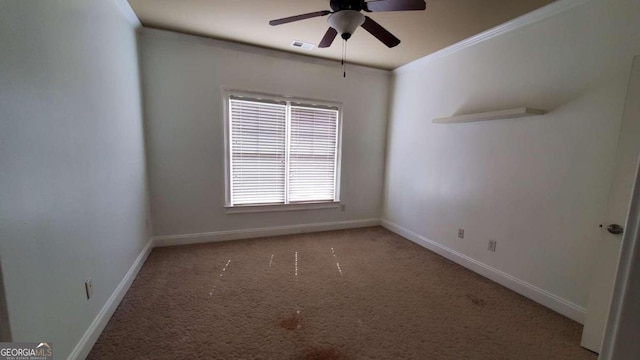 carpeted spare room with ornamental molding and ceiling fan