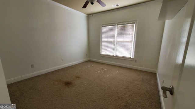 carpeted empty room with crown molding and ceiling fan