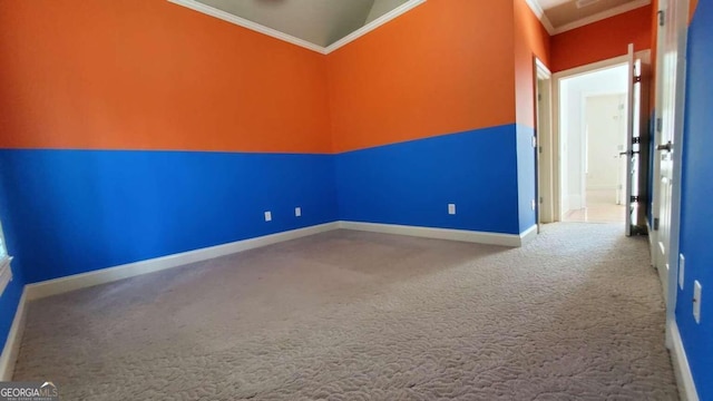 empty room with carpet flooring, ornamental molding, and vaulted ceiling