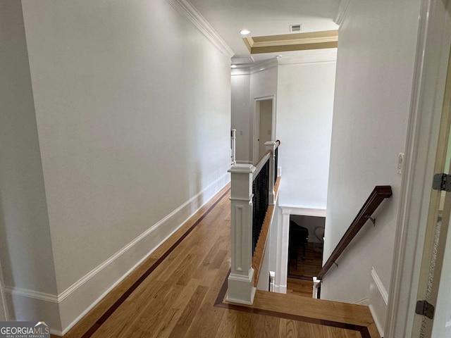 stairs with crown molding, recessed lighting, baseboards, wood finished floors, and visible vents